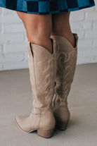 Knee Height light tan embroidered western style boots.