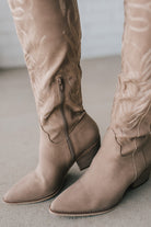 Knee Height light tan embroidered western style boots.