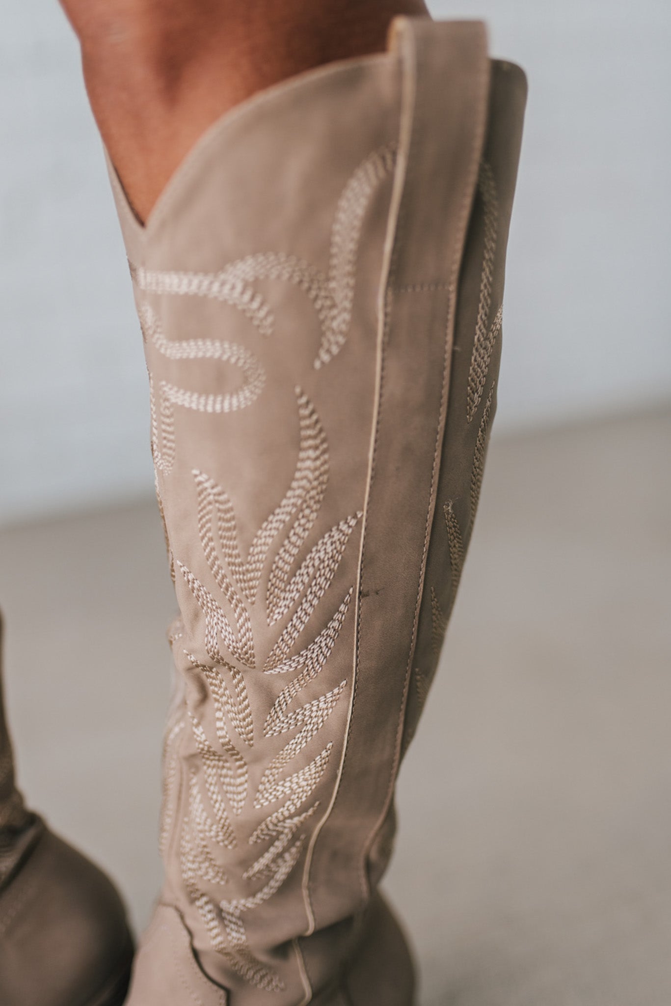 Knee Height light tan embroidered western style boots.