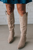 Knee Height light tan embroidered western style boots.