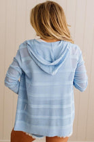 Light blue textured hoodie worn by a person with a neutral background