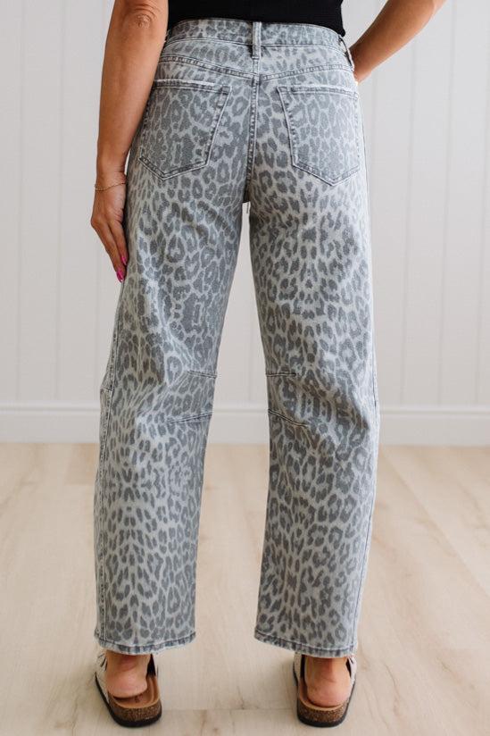 Leopard print pants worn by a person on a plain background