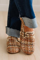 Womens footwear featuring a woven tweed upper with a statement buckle detail, set in an easy mule silhouette.