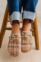 Womens footwear featuring a woven tweed upper with a statement buckle detail, set in an easy mule silhouette.