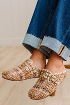 Womens footwear featuring a woven tweed upper with a statement buckle detail, set in an easy mule silhouette.