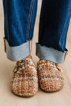 Womens footwear featuring a woven tweed upper with a statement buckle detail, set in an easy mule silhouette.