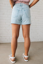Woman Wearing Light Wash Comfort Stretch Distressed Hem Denim Shorts