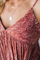 Blonde woman wearing a red Paisley Print Maxi Dress With Adjustable Straps.
