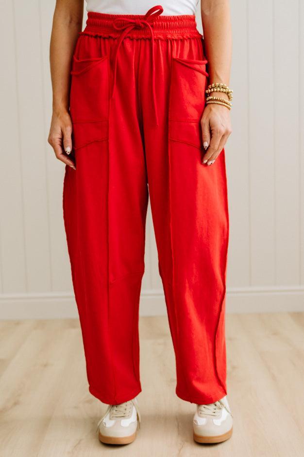 Person wearing red pants with a white background