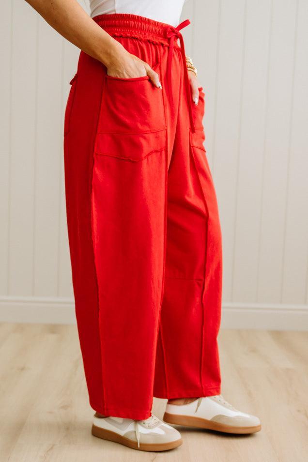 Person wearing red pants with a white background