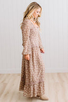 Latte brown colored Floral Drop Waist Maxi Dress on a blonde woman with a large white beaded necklace.