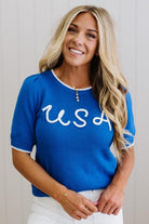 Woman wearing a blue 'USA' shirt against a plain background