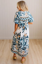 Woman wearing a floral dress with a neutral background