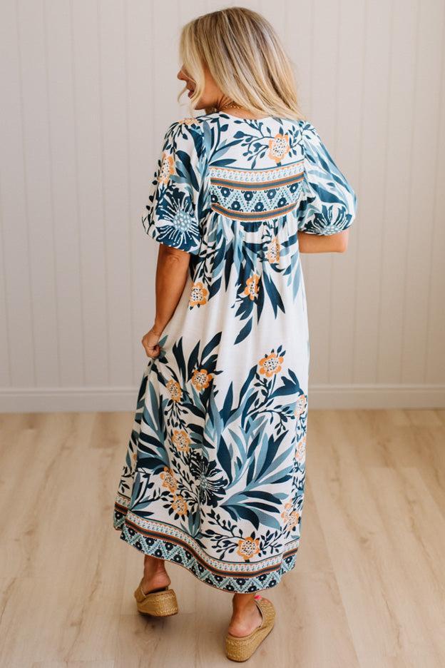 Woman wearing a floral dress with a neutral background