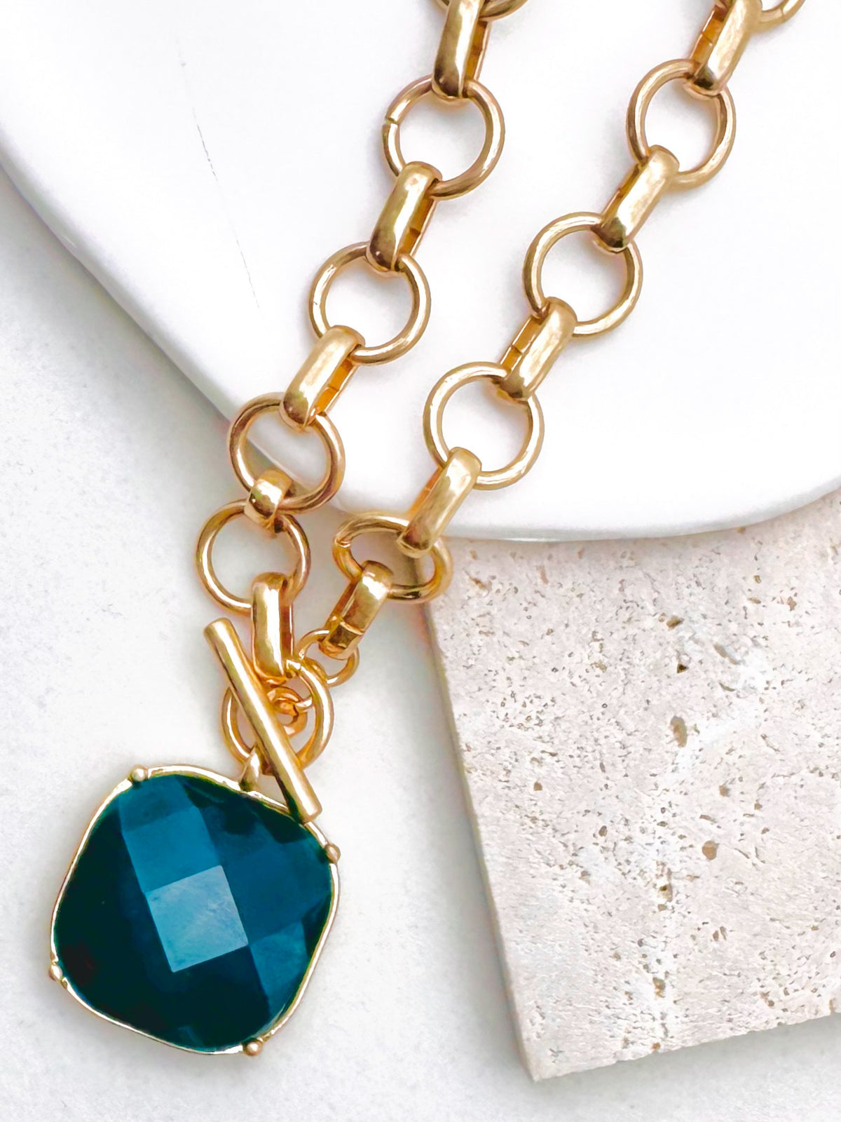 Uniform matte circle links meet at a working toggle front where a bezel framed cushion stone swings freely below the bar. Necklace length: 18 inches. The brushed finish plays against the glassy faceted surface for a tactile designer inspired contrast.