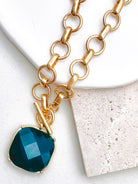 Uniform matte circle links meet at a working toggle front where a bezel framed cushion stone swings freely below the bar. Necklace length: 18 inches. The brushed finish plays against the glassy faceted surface for a tactile designer inspired contrast.