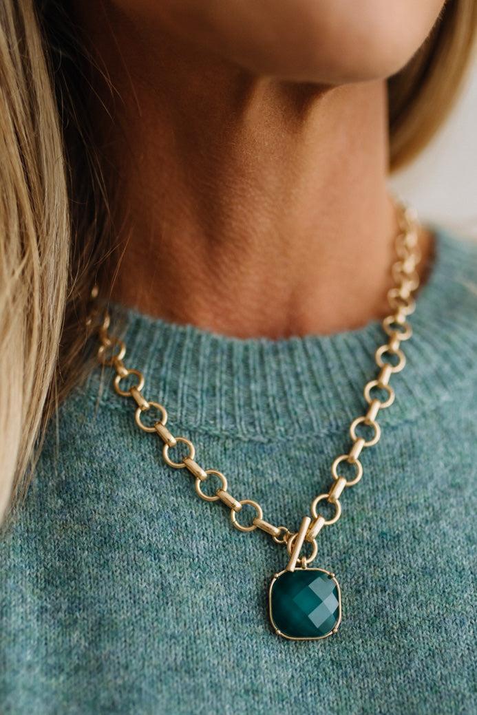 Uniform matte circle links meet at a working toggle front where a bezel framed cushion stone swings freely below the bar. Necklace length: 18 inches. The brushed finish plays against the glassy faceted surface for a tactile designer inspired contrast.