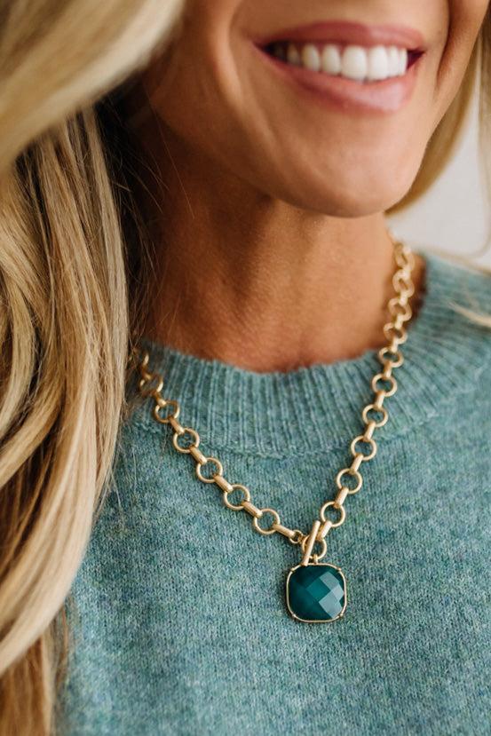 Uniform matte circle links meet at a working toggle front where a bezel framed cushion stone swings freely below the bar. Necklace length: 18 inches. The brushed finish plays against the glassy faceted surface for a tactile designer inspired contrast.