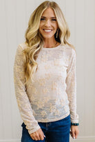 Blonde Woman Wearing A Floral Embroidered Stretch Lace Long Sleeve Top with Dark Jeans and Light Brown Belt.