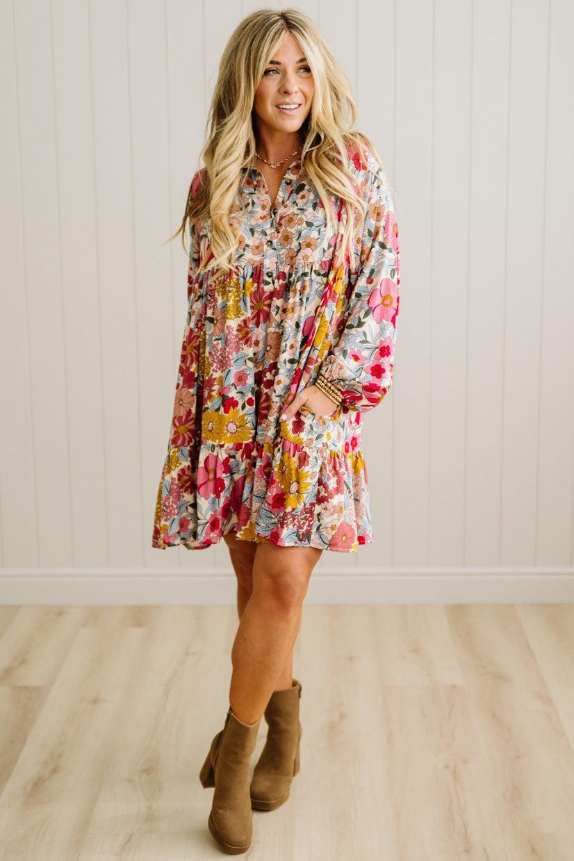 Woman wearing a floral dress with a plain background