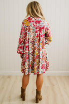 Woman wearing a floral dress with a white background