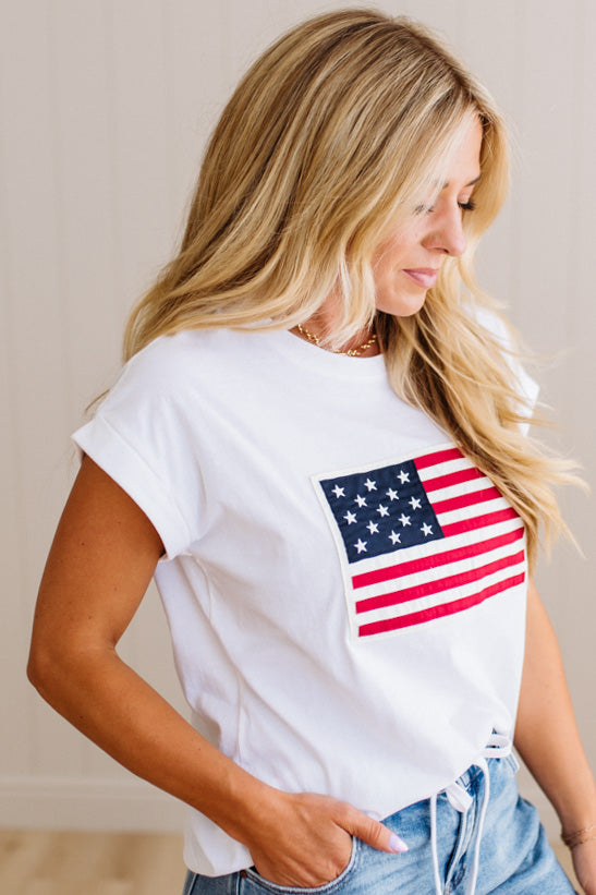 Woman wearing a white t-shirt with an American flag design.