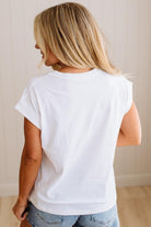 Person wearing a plain white t-shirt and light blue jeans against a neutral background