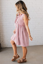 BLONDE WOMAN WEARING VERTICAL STRIPED TRIPLE FRONT BOW DETAIL MINI DRESS.