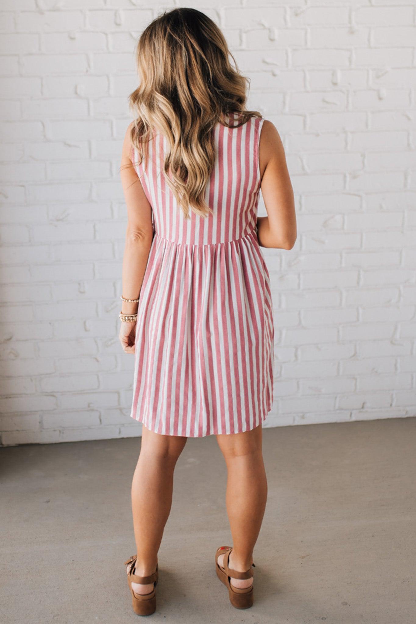 BLONDE WOMAN WEARING VERTICAL STRIPED TRIPLE FRONT BOW DETAIL MINI DRESS.