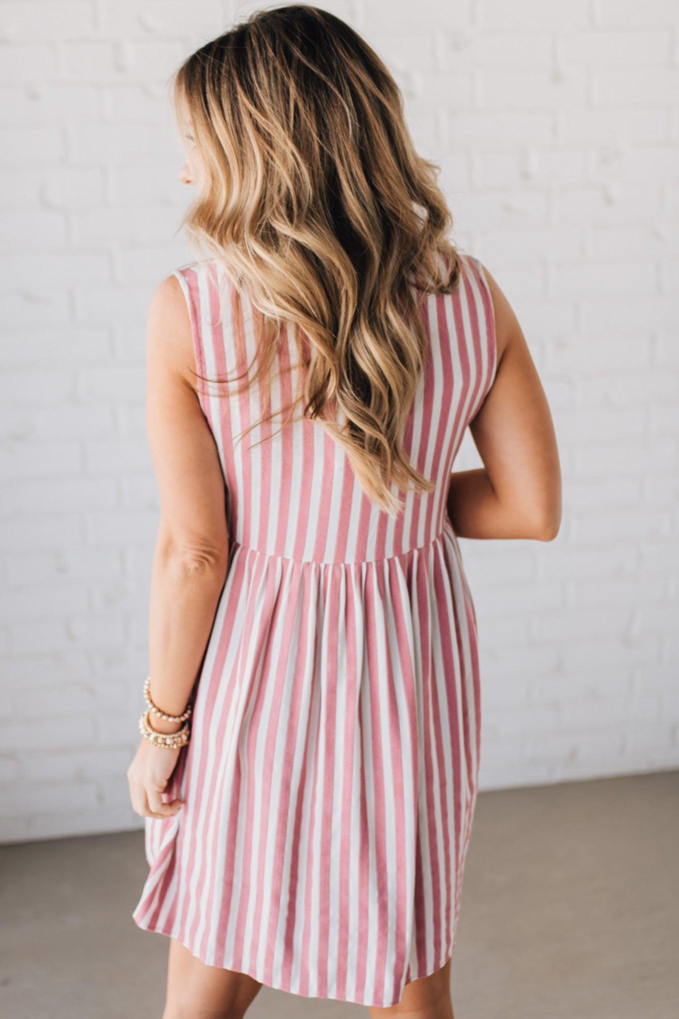 BLONDE WOMAN WEARING VERTICAL STRIPED TRIPLE FRONT BOW DETAIL MINI DRESS.