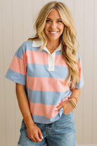 Woman wearing a striped shirt with a plain background