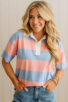 Woman wearing a striped shirt with a plain background