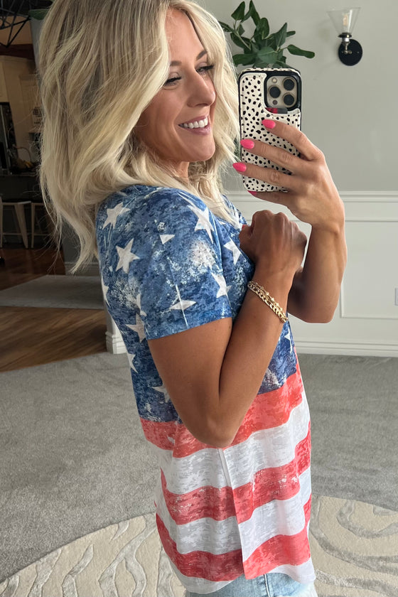 women wearing a red, white and blue American Flag V Neck tee and cut off denim shorts