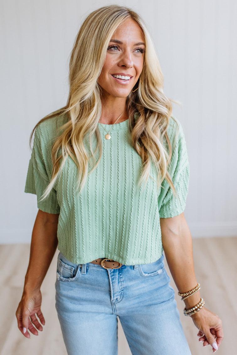 Blonde woman wearing a Lightweight Cable Knit T Shirt with Textured Vertical Cable-Inspired Knit and a Boxy Loose Silhouette with Drop-Shoulder detail.