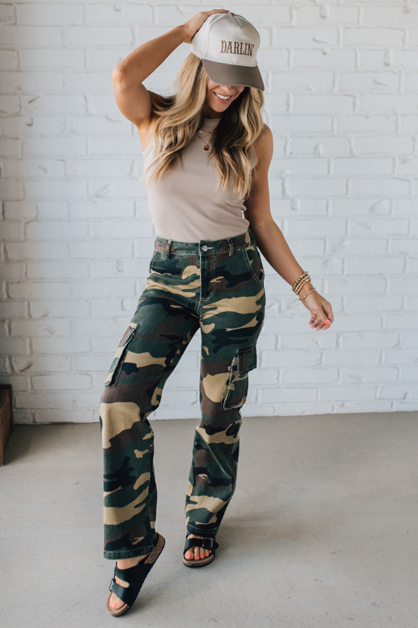Blonde Woman in a Tan Tank Wearing Camouflage Mid Rise Cargo Straight Pants.