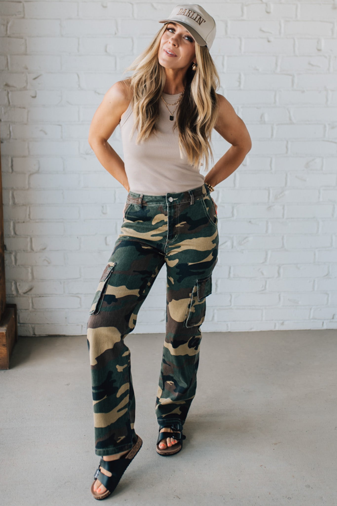 Blonde Woman in a Tan Tank Wearing Camouflage Mid Rise Cargo Straight Pants.