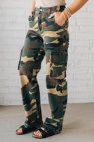 Blonde Woman in a Tan Tank Wearing Camouflage Mid Rise Cargo Straight Pants.