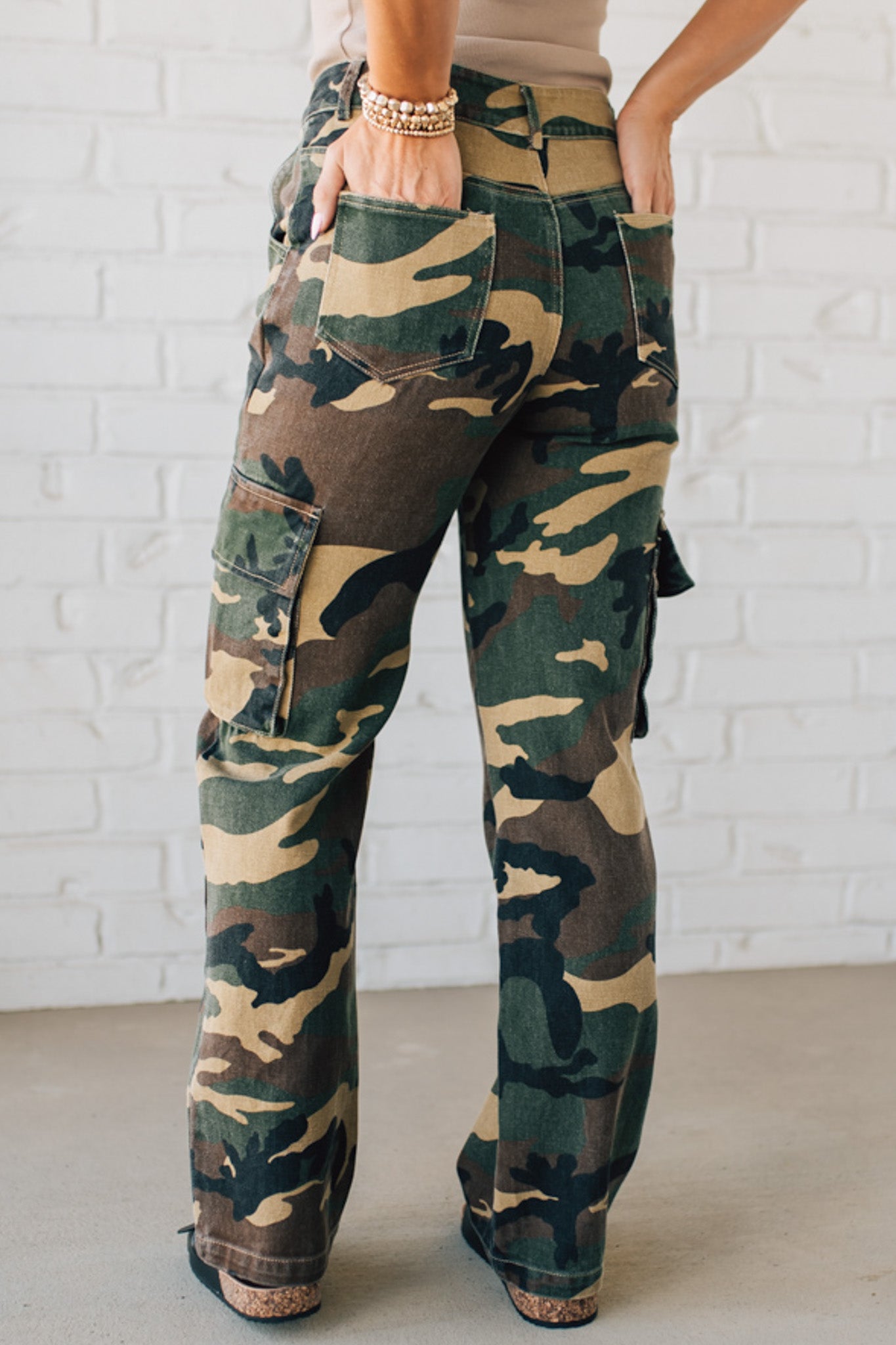 Blonde Woman in a Tan Tank Wearing Camouflage Mid Rise Cargo Straight Pants.