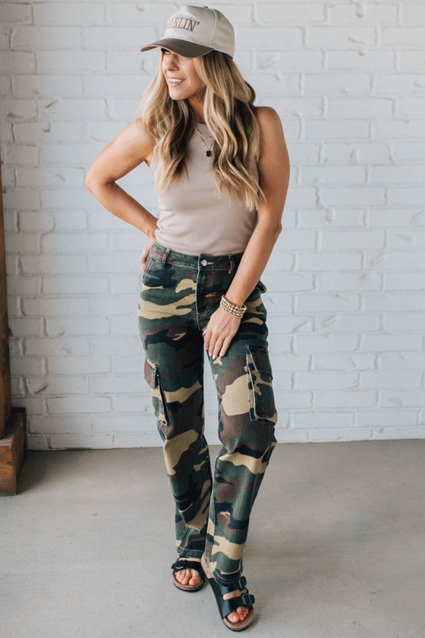 Blonde Woman in a Tan Tank Wearing Camouflage Mid Rise Cargo Straight Pants.