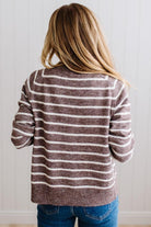 BLONDE WOMAN IN A BRIGHTLY LIT STUDIO WEARING A CREAM TANK AND DARK JEANS SHOWING A OUTSEAMED, LONG SLEEVE, FUZZY, CREW NECK STRIPED BUTTON DOWN SWEATER CARDIGAN IN CHOCOLATE MOCHA.