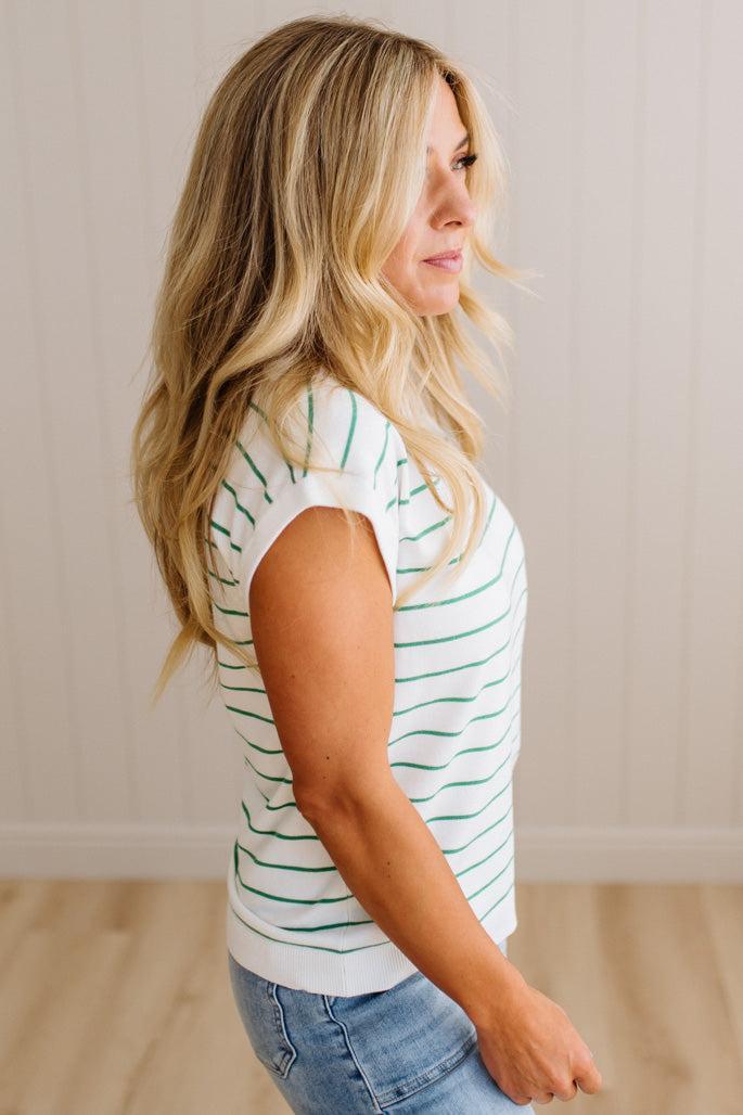 BLONDE WOMAN WEARING A STRIPED, CREW NECK, EXTENDED DOLMAN SHORT SLEEVE, EVERYDAY SWEATER TOP, IN IVORY WITH THIN KELLY GREEN STRIPE