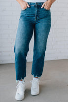 5'4" tall girl modeling a crop denim pant in a medium wash with a frayed hem and no distressing