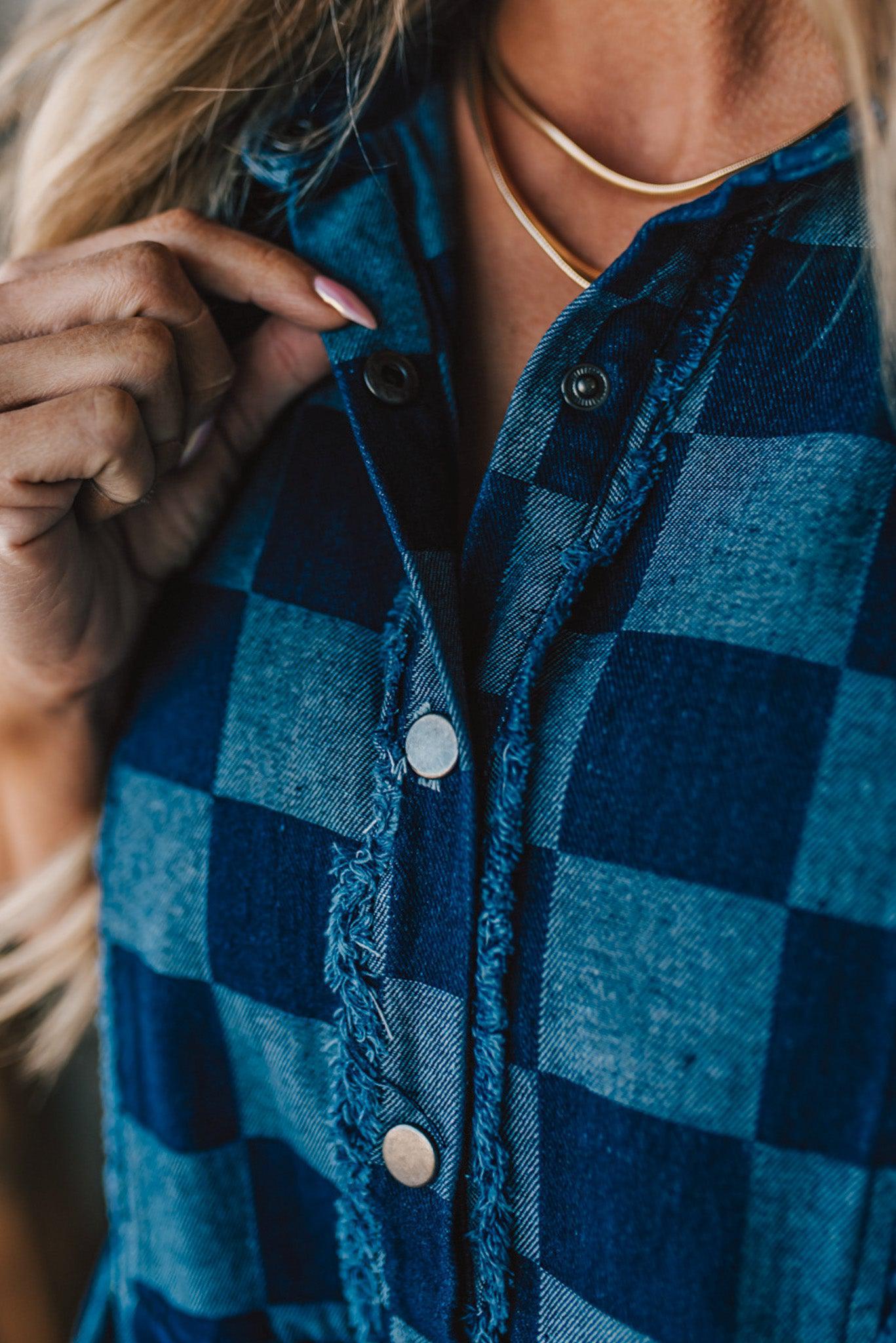 Blonde woman wearing a hat and boots with checkered denim knee length dress.