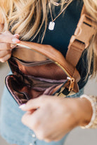 Blonde Woman in a Hat with a Mixed Texture Check Sling Belt Bum Bag across her body.