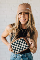 Blonde Woman in a Hat with a Mixed Texture Check Sling Belt Bum Bag across her body.