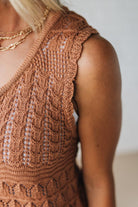 Close-up of a brown crochet top worn by a person.