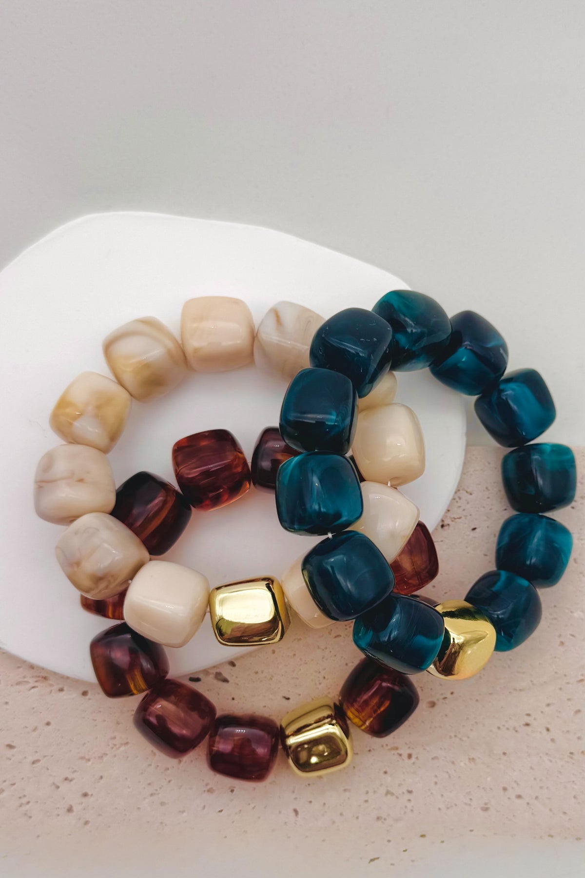 Dark Cyan bead bracelet with a gold accent bead shown on a woman's wrist in her pocket.