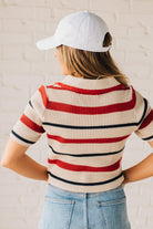 Blonde Woman in a White Hat Wearing a  Striped Collared Short Sleeve Cropped Sweater