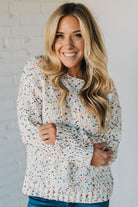 Woman wearing a patterned sweater against a white background