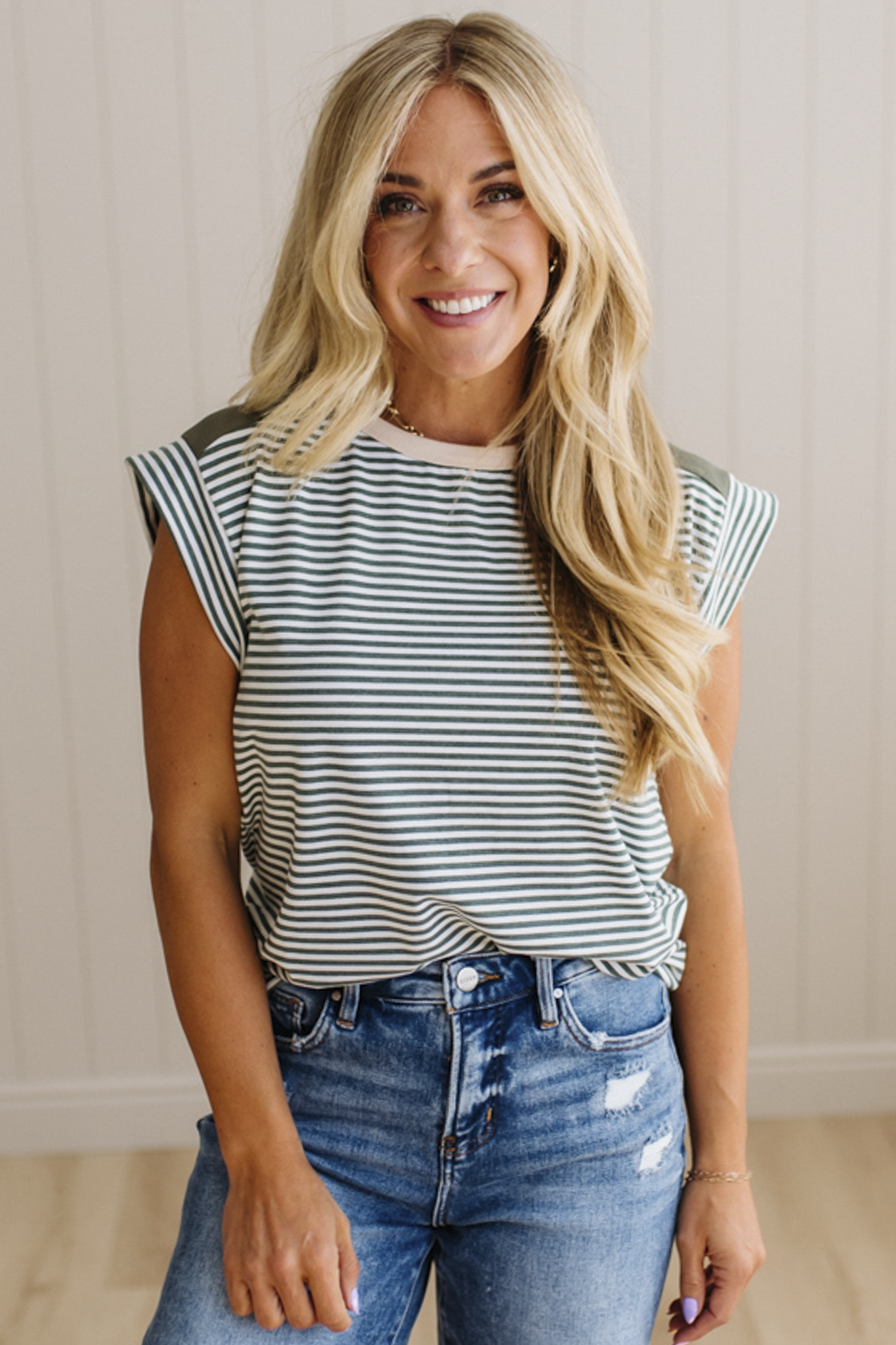 Woman wearing a striped shirt and jeans indoors